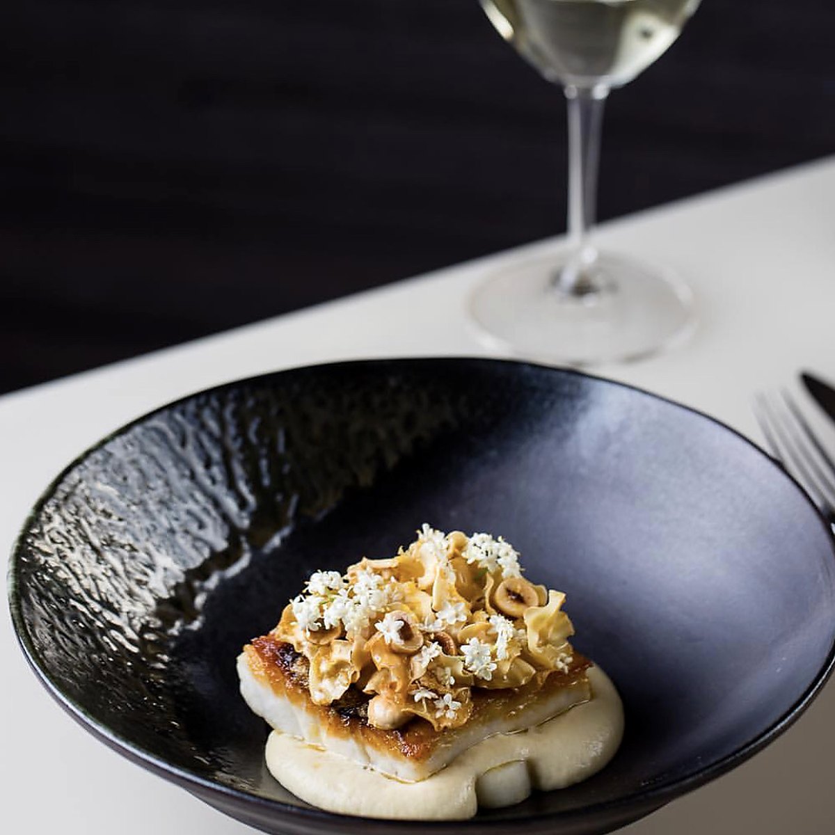 Roasted fish with hazelnuts and elderflower